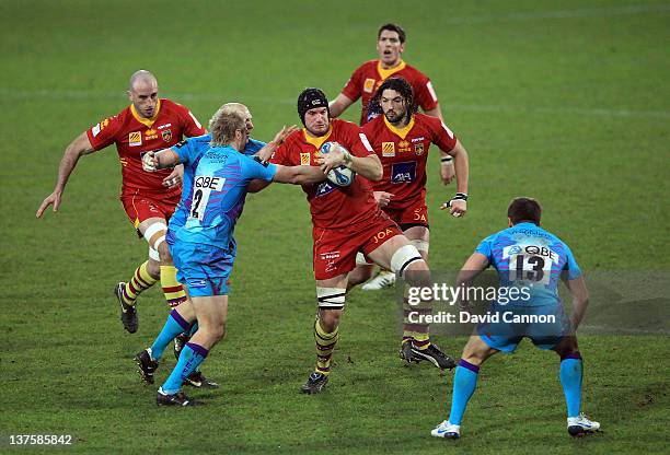 Jason Shoemark of Exeter Chiefs tackles Gerrie Britz of Perpignan during the Amlin Challenge Cup match between Exeter Chiefs and Perpignan at Sandy...