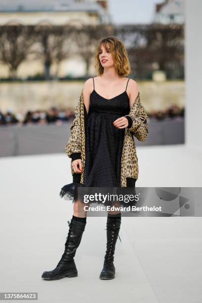 Maya Thurman-Hawke wears a black tulle with polka dots print pattern ruffled short dress, a beige with brown and black leopard print pattern zipper...