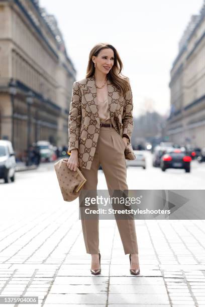Influencer Alexandra Lapp wearing a beige double breasted jumbo GG blazer by Gucci, gold city HardWear jewelry by Tiffany & Co., a beige silk top by...