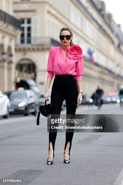 Influencer Alexandra Lapp wearing a black oversize blazer by Pernille x Mango, a pink flower accent blouse by Magda Butrym, black leggings by Saint...