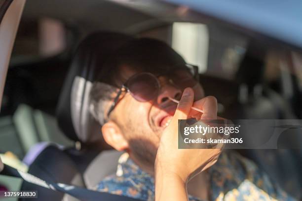 asian young adult driving  thru and waiting for swab covid-19 antigen test at drive thru medical testing spot - delta i stock pictures, royalty-free photos & images