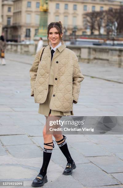 Maria Sharapova seen wearing beige puffer jacket, skirt, jacket, tie, knee high socks, loafers outside Dior during Paris Fashion Week - Womenswear...