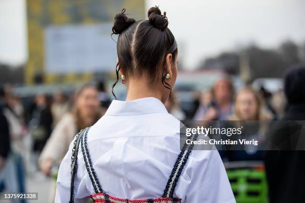 Sarah Lysander seen with pigtails wearing white button shirt, checkered dress, black bag outside Dior during Paris Fashion Week - Womenswear F/W...