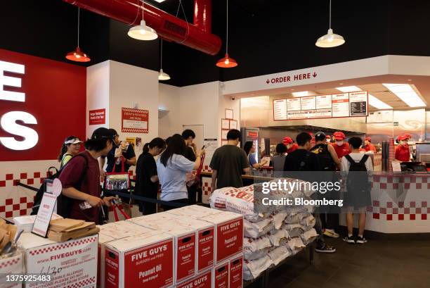 Customers inside the first outlet of US burger restaurant chain Five Guys in the Gangnam District of Seoul, South Korea, on Saturday, July 1, 2023....