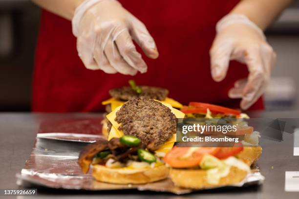 An employee prepares an order of burger at the first outlet of US burger restaurant chain Five Guys in the Gangnam District of Seoul, South Korea, on...