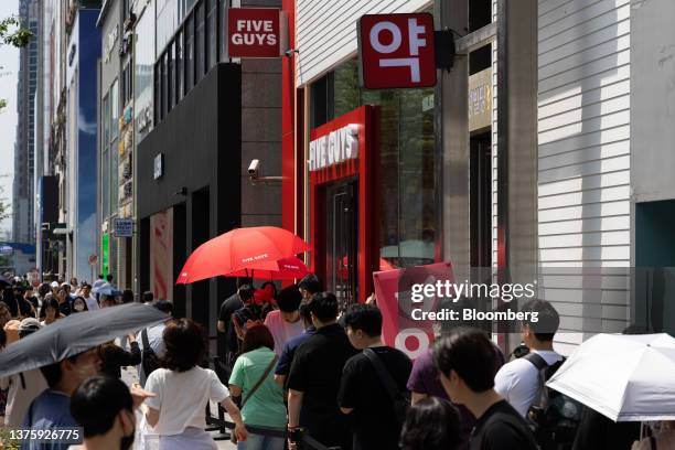 Customers wait in line to enter the first outlet of US burger restaurant chain Five Guys in the Gangnam District of Seoul, South Korea, on Saturday,...
