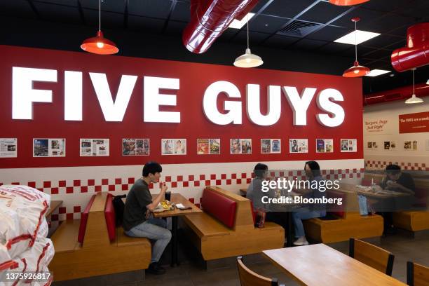 Customers dine inside the first outlet of US burger restaurant chain Five Guys in the Gangnam District of Seoul, South Korea, on Saturday, July 1,...
