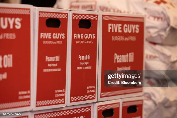 Boxes of peanut oil at the first outlet of US burger restaurant chain Five Guys in the Gangnam District of Seoul, South Korea, on Saturday, July 1,...