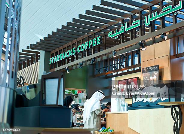 United Arab Emirates A sheikh at Starbucks coffee shop at Dubai Airport on December 25, 2011 in Dubai, United Arab Emirates