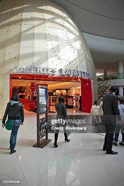 Visitors pass the entrance to a Galeries Lafayette SA department store in the Morocco Mall in Casablanca, Morocco, on Friday, Jan. 20, 2012. Tourism...