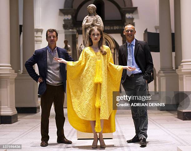 Textile expert Simon Peers and fashion designer Nicholas Godley stand beside model Bianca Gavrilas as she wears a hand-embroidered cape made from the...