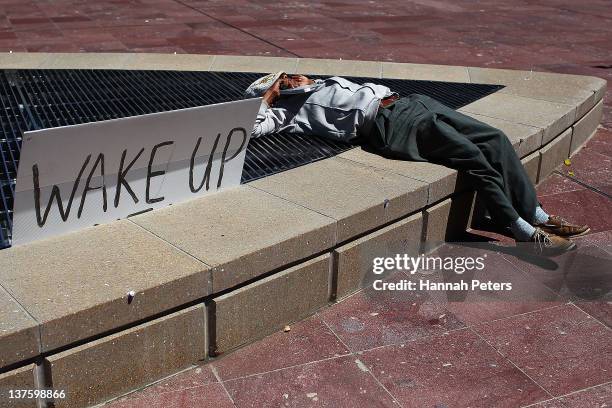 Protestor rests at Aotea Square on January 23, 2012 in Auckland, New Zealand. More than 30 police officers were on hand this morning when three...