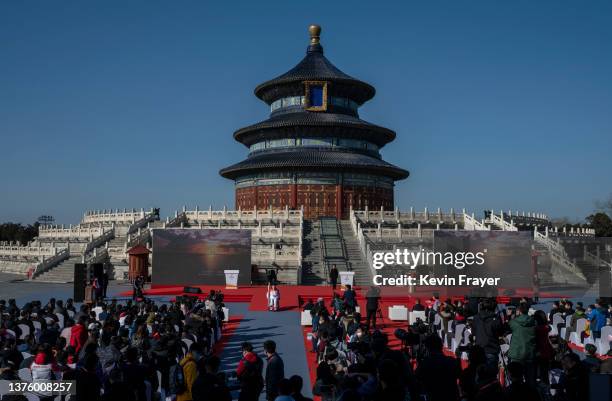 Chinese Paralympic athlete Chen Jianxin, centre left, holds the torch as he participates in the Beijing 2022 Winter Paralympics Torch Relay at a...