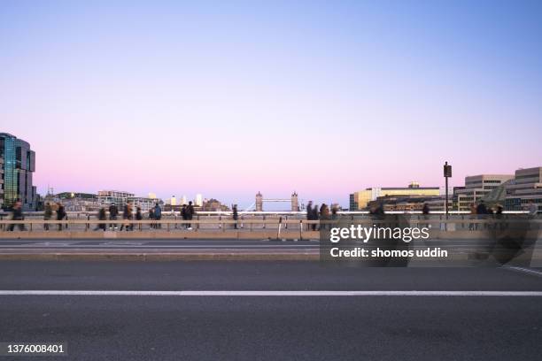 city road with travellers against london skyline at dusk - london bridge england stock pictures, royalty-free photos & images