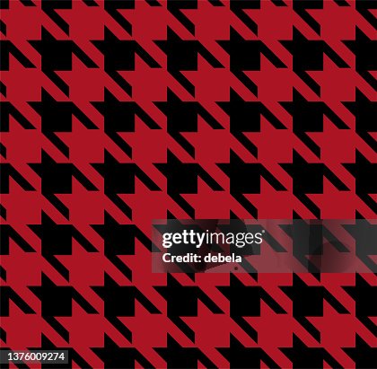 Red and black houndstooth check pattern close-up. Red and black houndstooth check pattern close-up.