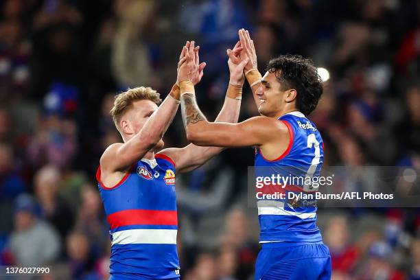 Jamarra Ugle-Hagan of the Bulldogs celebrates a goal with teammate Adam Treloar during the 2023 AFL Round 16 match between the Western Bulldogs and...