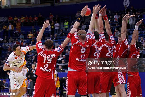 Kiril Lazarov of Macedonia shoots over defending Poland players during the Men's European Handball Championship 2012 second round group one match...