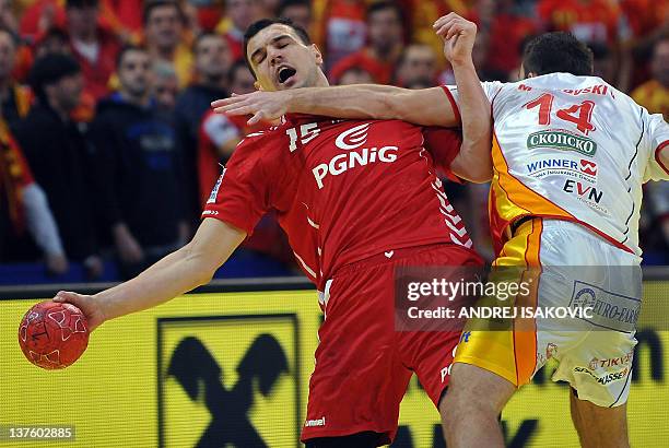 Poland's Mihal Jurecki vies with Macedonia's Velko Markoski during the men's EHF Euro 2012 Handball Championship match Poland vs Macedonia on January...