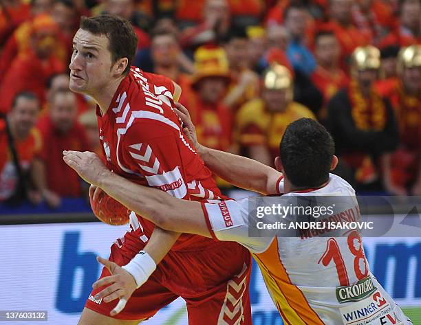 Poland's Mariusz Jurkiewicz vies with FYR Macedonia's Naumche Mojsovski during their men's EHF Euro 2012 Handball Championship match between Poland...