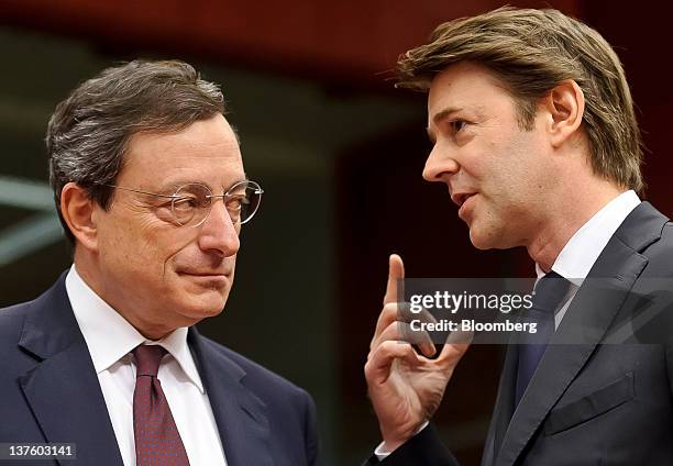 Mario Draghi, president of the European Central Bank , left, speaks with Francois Baroin, France's finance minister, during a Eurogroup finance...