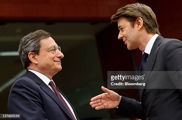 Mario Draghi, president of the European Central Bank , left, speaks with Francois Baroin, France's finance minister, during a Eurogroup finance...
