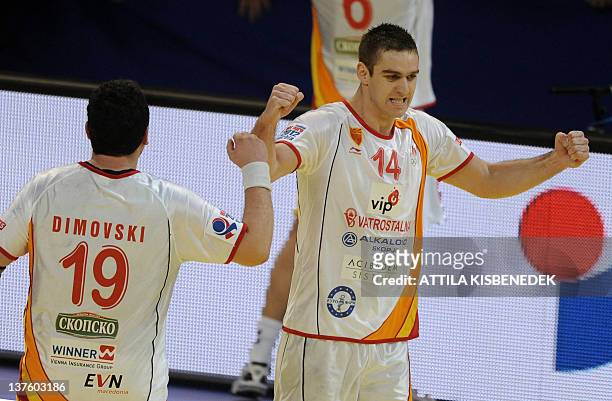 Macedonia's players Velko Markoski and Vancho Dimovski celebrate their victory against Poland after the men's EHF Euro 2012 Handball Championship...