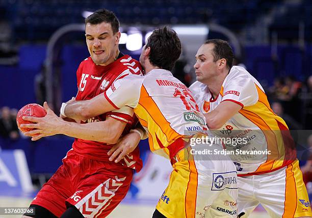 Mihal Jurecki of Poland vies with Filip Mirkulovski of Macedonia, during the Men's European Handball Championship 2012 second round group one, match...