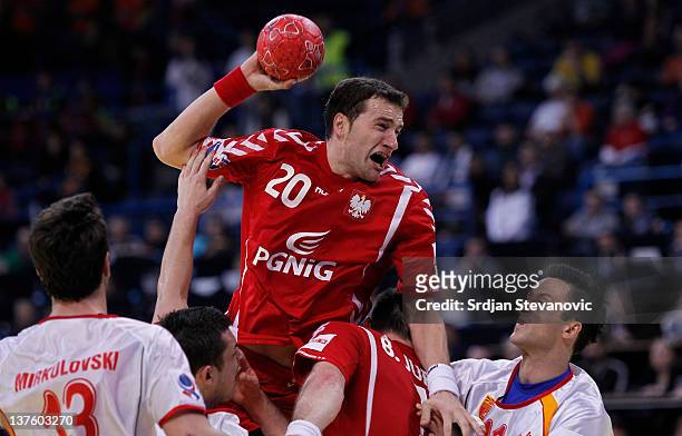 Mariusz Jurkiewiczi of Poland competes with Velko Markoski of Macedonia, during the Men's European Handball Championship 2012 second round group one,...