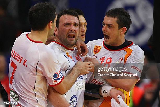 Kiril Lazarov , Zlatko Mojsoski and Naumche Mojsovski of Macedonia celebrate the 27-25 victory after the Men's European Handball Championship second...