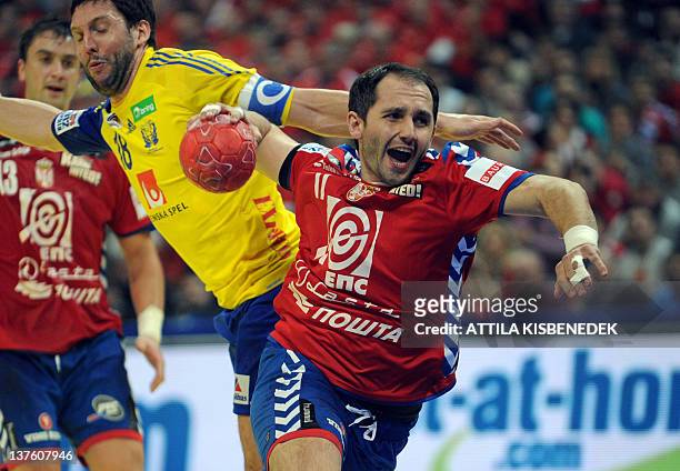 Serbia's Alem Toskic vies with Sweden's Tobias Karlsson during the men's EHF Euro 2012 Handball Championship match between Serbia and Sweden at the...