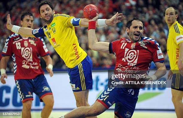 Serbia's Alem Toskic scores past Sweden's Tobias Karlsson during the men's EHF Euro 2012 Handball Championship match between Serbia and Sweden at the...