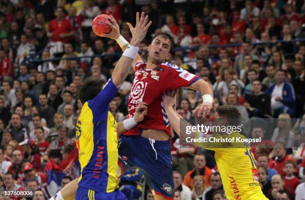 Tobias Karlsson and Niclas Ekberg of Sweden defend against Momir Ilic of Serbia during the Men's European Handball Championship second round group...