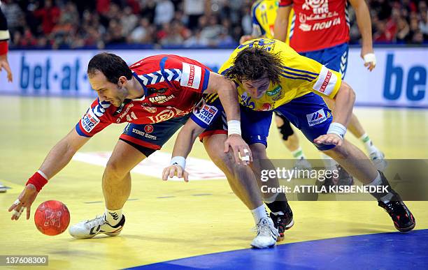 Serbian Alem Toskic fights for the ball with Swedish Andreas Nilsson during the Men's EHF Euro 2012 Handball Championship match Serbia vs Sweden on...