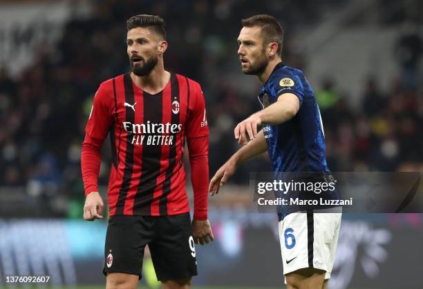 Olivier Giroud of AC Milan and Stefan De Vrij of Internazionale look on during the Coppa Italia Semi Final 1st Leg match between AC Milan and FC...