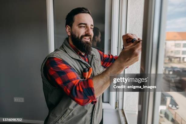 handyman fixing the window - window installation stock pictures, royalty-free photos & images