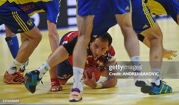 Serbia's Alem Toskic vies with Sweden's players during their men's EHF Euro 2012 Handball Championship match between Serbia and Sweden at the...