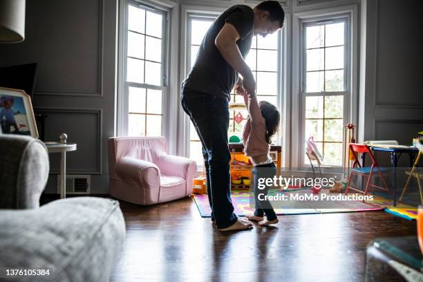 toddler daughter dancing her on father's feet - dancing feet stock pictures, royalty-free photos & images