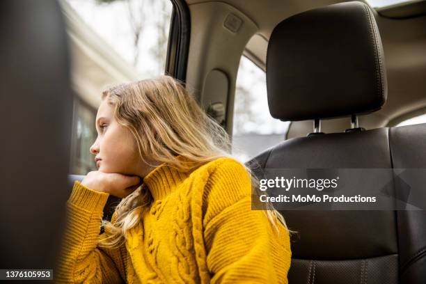 tween girl sitting in back seat of automobile - yellow car stock pictures, royalty-free photos & images