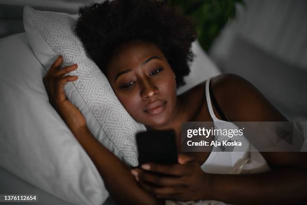 what keeps me awake at night. - african american woman pajamas residential building stock pictures, royalty-free photos & images