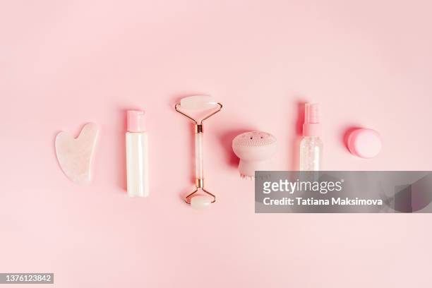 cosmetics for face care on pink background. - human skin background stock pictures, royalty-free photos & images