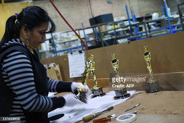 Josefina Govea Guerrero, an employee of R.S. Owens packs up an Oscar statuette at a factory in Chicago, Illinois on December 6, 2011. Nominations for...