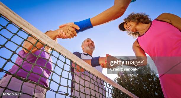 tennis players shaking hand on clay court - purple clay stock pictures, royalty-free photos & images
