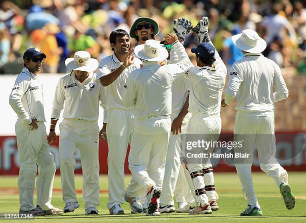 Zaheer Khan of India celebrates with team mates after taking the wicket of David Warner of Australia during day one of the Fourth Test Match between...