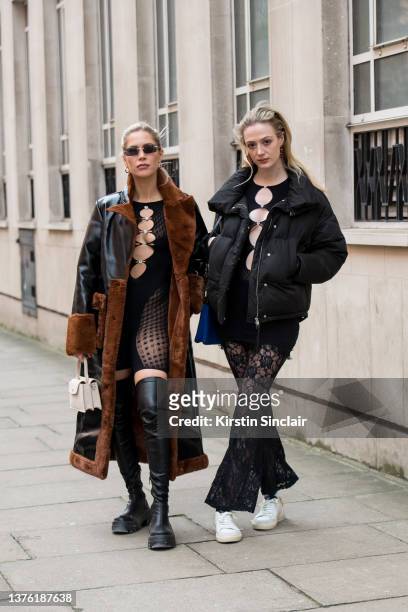 Thea Carroll wears a Poster Girl playsuit, thigh high black boots and a black and brown faux fur shearling coat with Georgie Fairhurst wearing a...