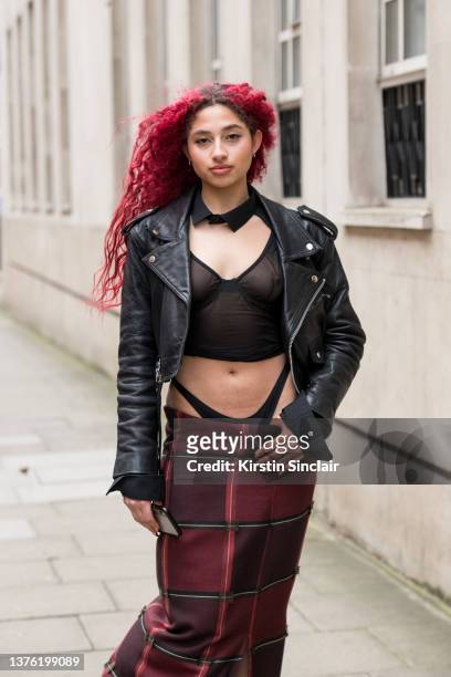 Jadzia Scott wears a La Senza top, Goldsmith vintage jacket and a checked skirt during London Fashion Week February 2022 on February 18, 2022 in...
