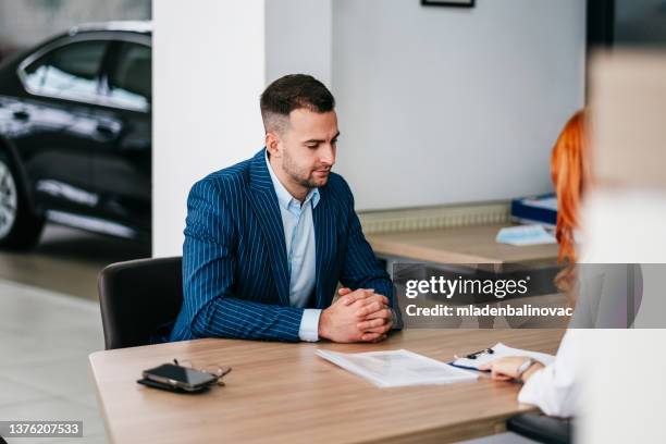 successful deal in a car showroom! - motor vehicle department stock pictures, royalty-free photos & images