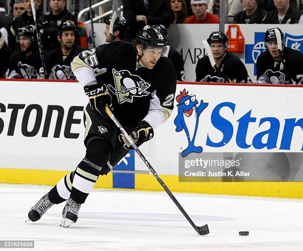 Eric Tangradi of the Pittsburgh Penguins skates the puck against the Washington Capitals during the game at Consol Energy Center on January 22, 2012...