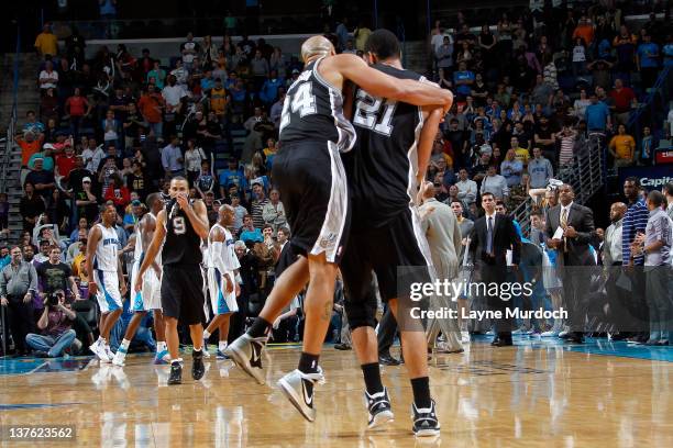 Tim Duncan of the San Antonio Spurs is congratulated by Richard Jefferson after scoring the game winning shot against the New Orleans Hornets on...