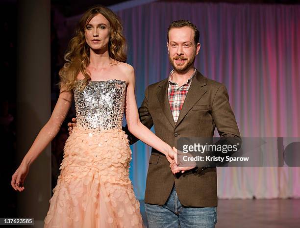 Jan Taminiau walks the runway with a model during the Jantaminiau Haute-Couture 2012 show as part of Paris Fashion Week at Le Laboratoire on January...