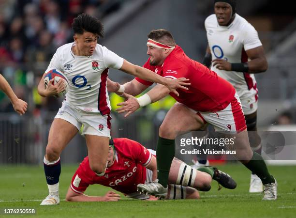 Marcus Smith of England escapes a tackle from Wyn Jones of Wales during the Guinness Six Nations Rugby match between England and Wales at Twickenham...